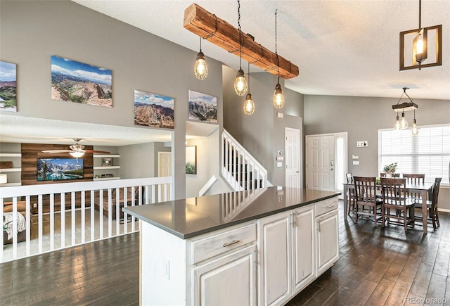 kitchen with dark countertops, dark wood finished floors, and a textured ceiling