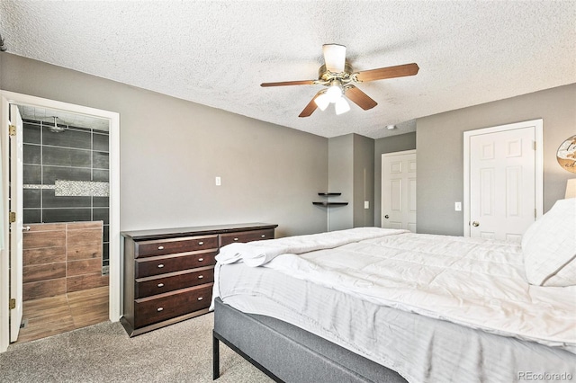 bedroom with a textured ceiling, ceiling fan, and carpet floors