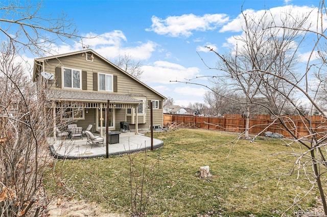 rear view of house featuring a patio, a lawn, a fenced backyard, and a shingled roof