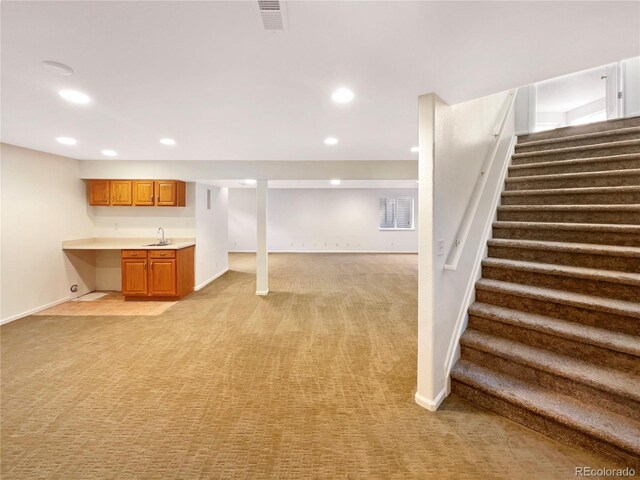 18951 E 43rd Ave, Denver, CO 80249 - finished basement featuring light colored carpet, a sink, visible vents, and stairway
