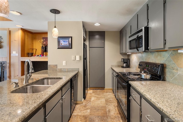 kitchen with black appliances, sink, light stone countertops, and tasteful backsplash