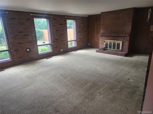 6961 E Arkansas Ave, Denver, CO 80224 - unfurnished living room featuring carpet floors, a fireplace, and brick wall