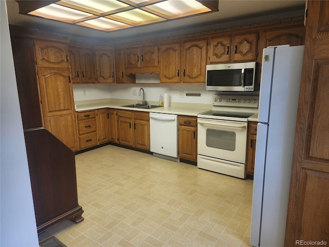 6961 E Arkansas Ave, Denver, CO 80224 - kitchen featuring white appliances, light countertops, and brown cabinetry