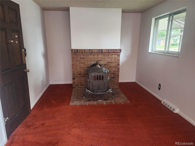 6961 E Arkansas Ave, Denver, CO 80224 - carpeted living area with a wood stove and baseboards