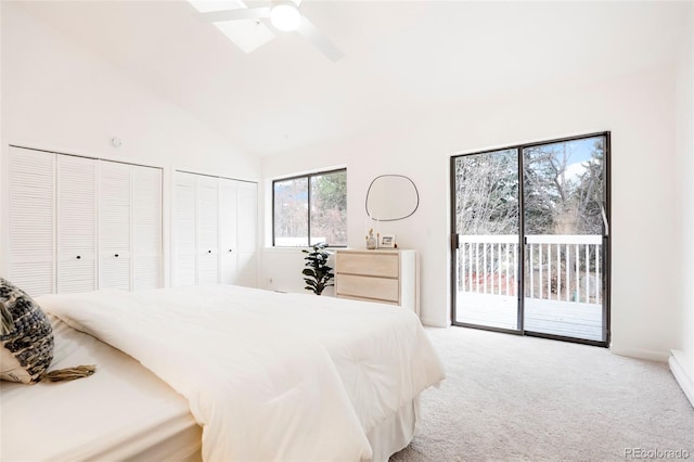 carpeted bedroom featuring high vaulted ceiling, access to exterior, two closets, and ceiling fan