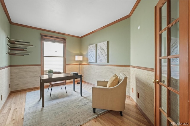 office featuring wood finished floors, a wainscoted wall, and ornamental molding