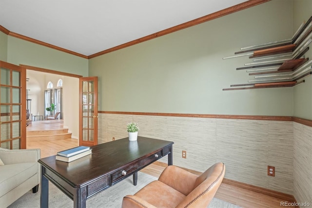 office space with wood finished floors, a wainscoted wall, crown molding, french doors, and tile walls