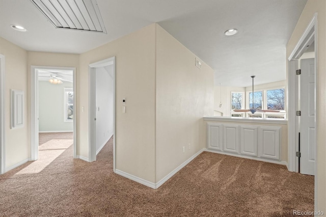 hall with recessed lighting, carpet, and baseboards