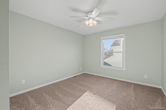 empty room featuring visible vents, a ceiling fan, baseboards, and carpet floors