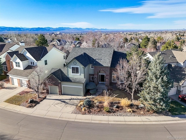 drone / aerial view featuring a residential view and a mountain view