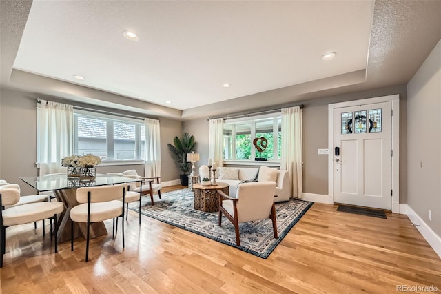 2692 N Raleigh St, Denver, CO 80212 - living area featuring a tray ceiling, light wood-style flooring, plenty of natural light, and recessed lighting