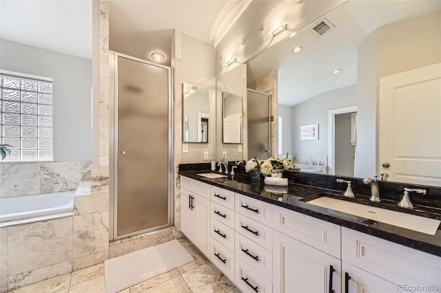 2692 N Raleigh St, Denver, CO 80212 - bathroom with double vanity, a shower stall, a bath, and lofted ceiling