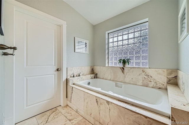 2692 N Raleigh St, Denver, CO 80212 - bathroom with a garden tub, vaulted ceiling, and marble look tile flooring