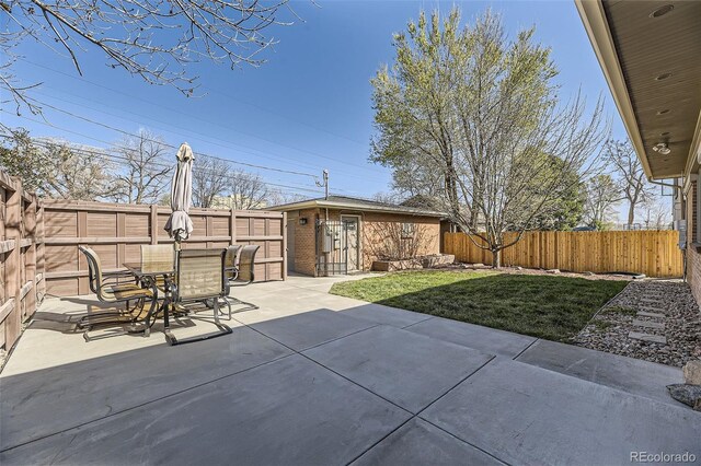 2692 N Raleigh St, Denver, CO 80212 - fenced backyard with an outbuilding, a patio area, and outdoor dining space