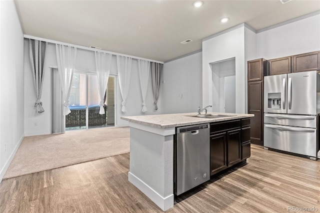 14301 E Tennessee Ave Unit 109, Aurora, CO 80012 - kitchen with stainless steel appliances, a sink, light countertops, an island with sink, and light wood-style flooring