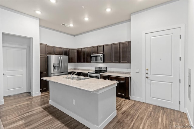 14301 E Tennessee Ave Unit 109, Aurora, CO 80012 - kitchen with appliances with stainless steel finishes, a sink, dark brown cabinets, wood finished floors, and recessed lighting
