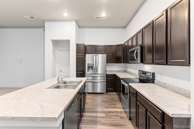 14301 E Tennessee Ave Unit 109, Aurora, CO 80012 - kitchen with stainless steel appliances, a sink, dark brown cabinets, light countertops, and recessed lighting