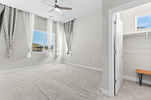 14301 E Tennessee Ave Unit 109, Aurora, CO 80012 - unfurnished bedroom featuring multiple windows, carpet flooring, baseboards, and a ceiling fan