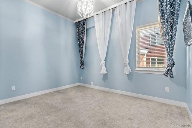 14301 E Tennessee Ave Unit 109, Aurora, CO 80012 - spare room featuring carpet floors, a chandelier, baseboards, and crown molding