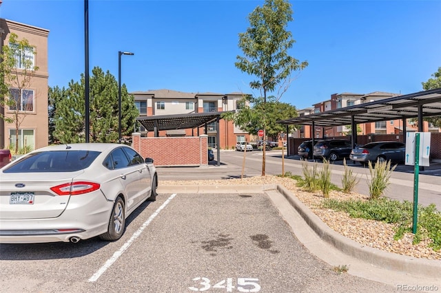 14301 E Tennessee Ave Unit 109, Aurora, CO 80012 - view of asphalt road with street lights and curbs