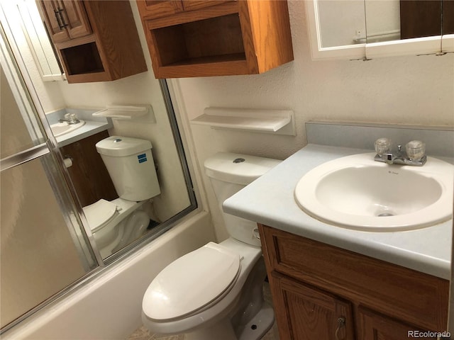 full bathroom with vanity, toilet, and combined bath / shower with glass door