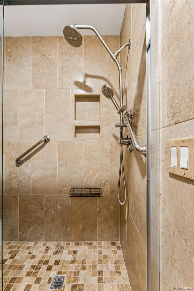 bathroom with tiled shower