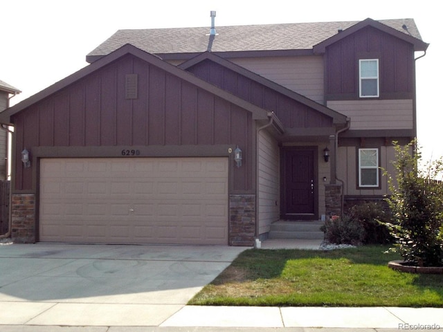 view of front of property featuring a garage, board and batten siding, driveway, and stone siding