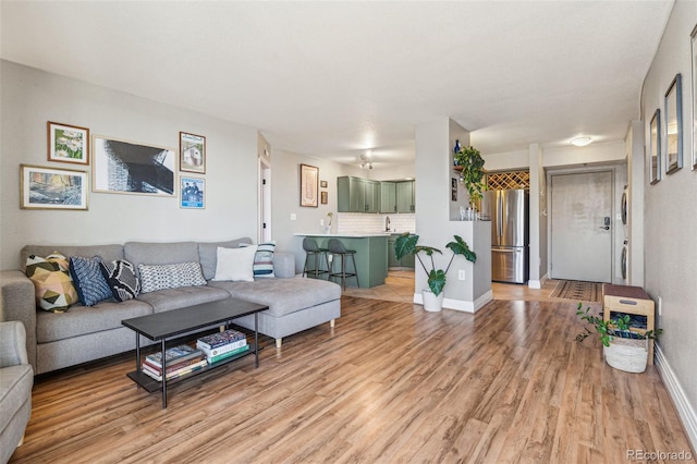 living room with wood-type flooring and sink