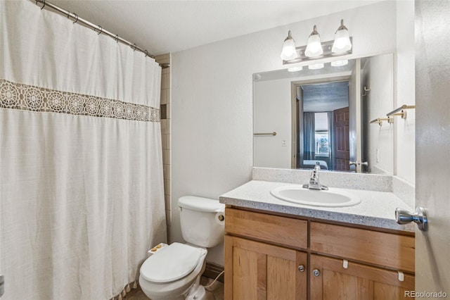 bathroom featuring vanity, a shower with shower curtain, and toilet