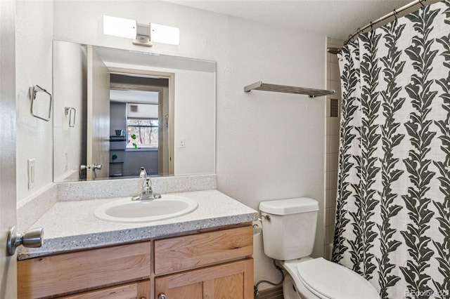 bathroom featuring vanity, toilet, and a shower with shower curtain