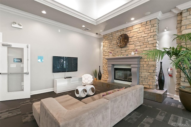 living room with ornamental molding and a large fireplace