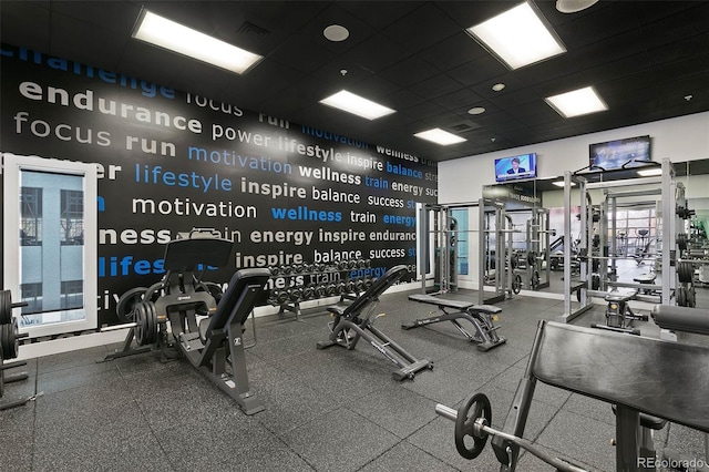 workout area with a paneled ceiling