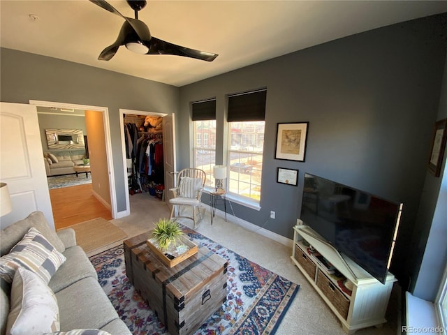 carpeted living room with ceiling fan