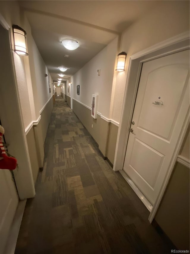 hallway with dark carpet