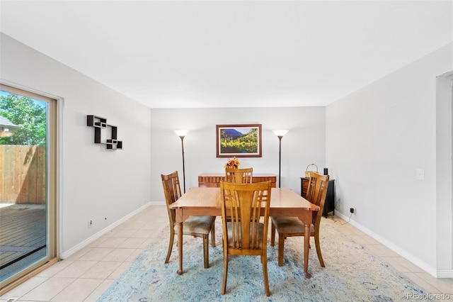 dining room featuring light tile patterned flooring and baseboards