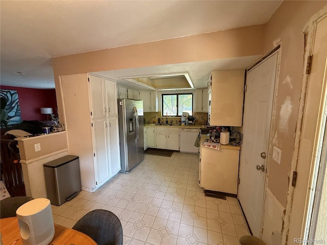 8995 E Cornell Ave, Denver, CO 80231 - kitchen with stainless steel fridge, dishwasher, white cabinets, and light countertops