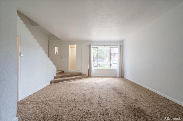 unfurnished living room featuring carpet floors