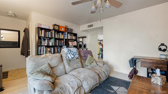 living room with ceiling fan and light hardwood / wood-style flooring