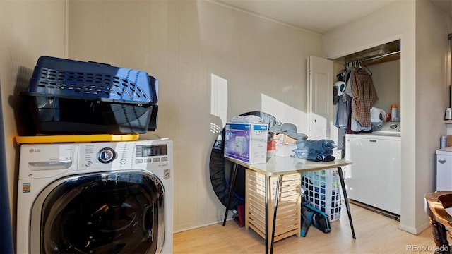 laundry area with hardwood / wood-style floors and washing machine and dryer