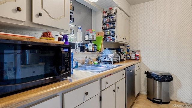 kitchen featuring sink, white cabinets, and appliances with stainless steel finishes