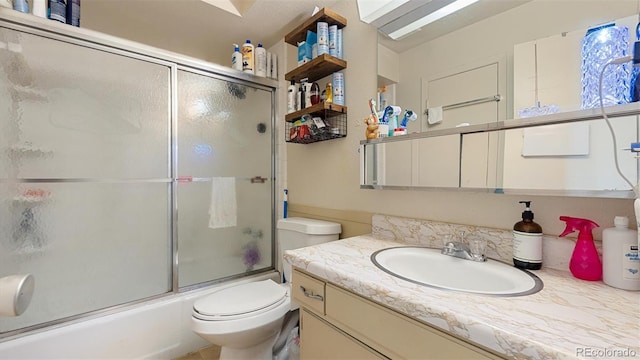 full bathroom featuring vanity, toilet, and enclosed tub / shower combo