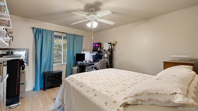 bedroom with ceiling fan and light wood-type flooring