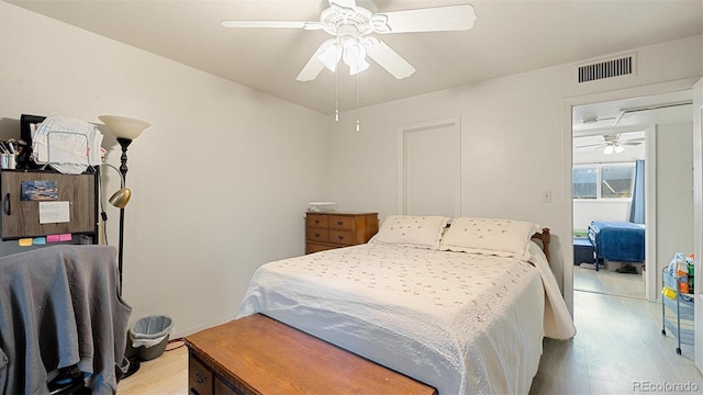 bedroom with ceiling fan and light hardwood / wood-style floors