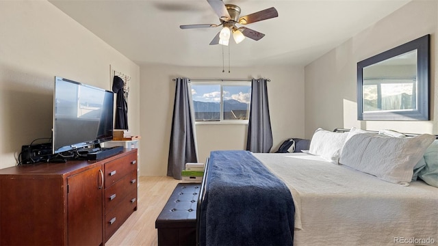 bedroom with ceiling fan and light hardwood / wood-style flooring