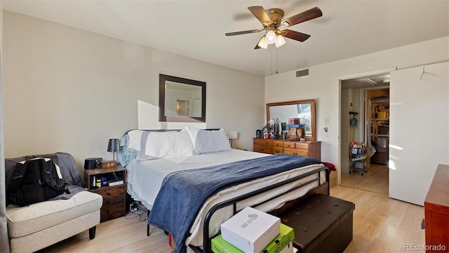 bedroom with ceiling fan and light hardwood / wood-style flooring