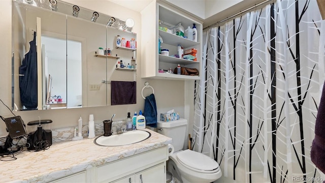 bathroom featuring vanity, curtained shower, and toilet