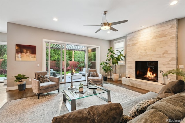445 Forest St, Denver, CO 80220 - living room featuring plenty of natural light, a ceiling fan, recessed lighting, wood finished floors, and a tiled fireplace