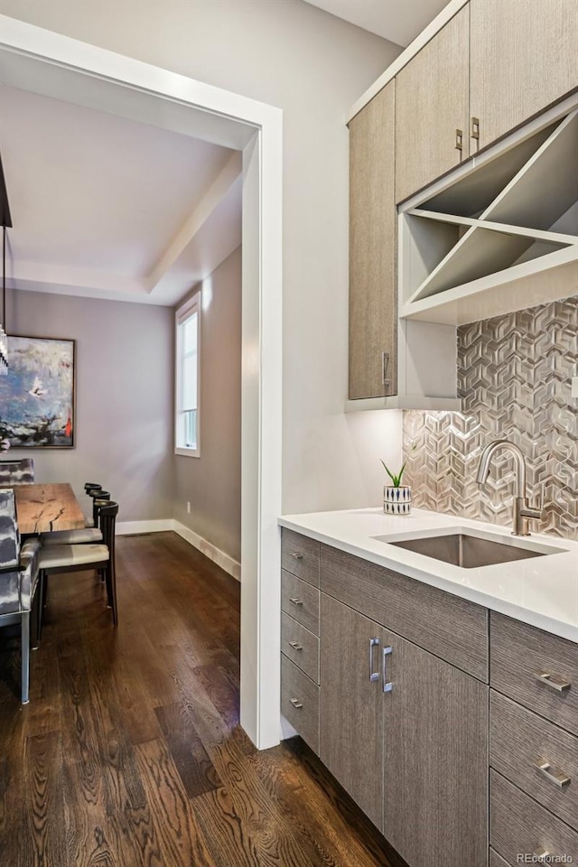 445 Forest St, Denver, CO 80220 - kitchen featuring dark wood-style flooring, light countertops, and backsplash