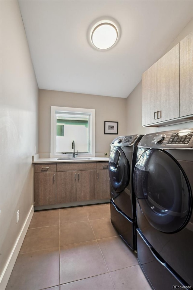 445 Forest St, Denver, CO 80220 - laundry area featuring washer and dryer, cabinet space, and light tile patterned flooring
