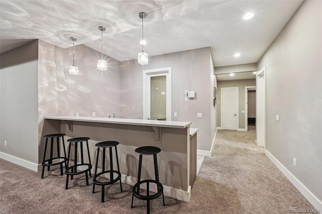445 Forest St, Denver, CO 80220 - kitchen with carpet, a kitchen breakfast bar, a peninsula, decorative light fixtures, and recessed lighting